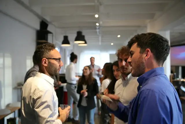 Founders talking with partners at an international startup event